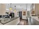 Well-lit kitchen featuring granite countertops, black appliances, and wood-look flooring at 707 Carpenters Way # 37, Lakeland, FL 33809