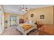 Main bedroom with vaulted ceiling, balcony access, and warm natural light at 707 Carpenters Way # 37, Lakeland, FL 33809