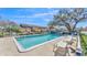 Outdoor community pool area with lounge chairs, shade trees, and a community building at 707 Carpenters Way # 37, Lakeland, FL 33809