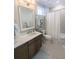 Bathroom showcasing a single sink vanity, granite countertops, a mirror, and a shower with curtain at 7903 Lake James Blvd, Lakeland, FL 33810