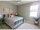 Comfortable bedroom with neutral walls, a ceiling fan, and a double-hung window offering plenty of natural light at 7903 Lake James Blvd, Lakeland, FL 33810