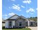 Beautiful single-story home with stone accents, well-manicured lawn, and paver driveway at 7903 Lake James Blvd, Lakeland, FL 33810