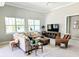 Bright living room with tile floors, neutral tones, and cozy furniture for relaxation at 7903 Lake James Blvd, Lakeland, FL 33810