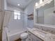 Cozy bathroom features a shower-tub combination with a granite-topped single sink vanity at 8160 Lake James Dr, Lakeland, FL 33810