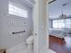 Well-lit bathroom includes toilet and framed Parisian art above the toilet at 8160 Lake James Dr, Lakeland, FL 33810