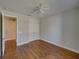 Bright bedroom with ceiling fan, hardwood floors, and double-door closet at 8160 Lake James Dr, Lakeland, FL 33810