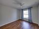 Empty bedroom with hardwood floors, ceiling fan, and a window at 8160 Lake James Dr, Lakeland, FL 33810