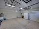 Clean and well-lit garage with epoxy flooring, overhead storage, and utility sink at 8160 Lake James Dr, Lakeland, FL 33810