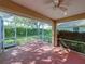 Enclosed lanai area with screened walls, offering a view of the backyard and greenery at 8160 Lake James Dr, Lakeland, FL 33810