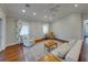 Neutral toned living room with wood floors, area rug, seating and bright, natural light at 8160 Lake James Dr, Lakeland, FL 33810