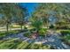 Community park and seating area under mature trees with lush, green landscaping at 8160 Lake James Dr, Lakeland, FL 33810