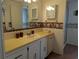 Bathroom features a vanity with sink, decorative wallpaper, and shower and bathtub combination at 1007 Forest Lake Dr, Lakeland, FL 33809