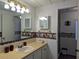 Bathroom with decorative wallpaper border, vanity with updated fixtures, and a mirror for added functionality at 1007 Forest Lake Dr, Lakeland, FL 33809