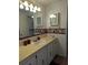 Bright bathroom featuring a sink, vanity, and a decorative wallpaper border, offering a functional space at 1007 Forest Lake Dr, Lakeland, FL 33809