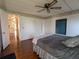 Cozy bedroom leading to a kitchen with wood floors and plenty of light at 1007 Forest Lake Dr, Lakeland, FL 33809