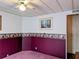 Bedroom featuring purple carpet, ample wall decor, and ceiling fan provides a comfortable private space at 1007 Forest Lake Dr, Lakeland, FL 33809