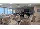 Bright dining room with multiple tables and chairs, a bar, and a large flat screen television at 1007 Forest Lake Dr, Lakeland, FL 33809