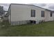 Exterior view of home featuring horizontal siding and a well-maintained lawn at 1007 Forest Lake Dr, Lakeland, FL 33809