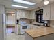 Well-lit kitchen featuring ample cabinet space, updated appliances, and an adjacent dining area at 1007 Forest Lake Dr, Lakeland, FL 33809