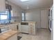 Efficient kitchen featuring wood countertops, white appliances, and tile flooring at 1007 Forest Lake Dr, Lakeland, FL 33809