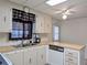 Functional kitchen space with stainless steel sink, wood countertops, and vintage dishwasher at 1007 Forest Lake Dr, Lakeland, FL 33809