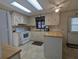 Traditional kitchen features white appliances, ample cabinetry, and tile floors, creating a functional space at 1007 Forest Lake Dr, Lakeland, FL 33809