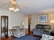 Cozy living room with wood floors, comfortable seating, and a decorative display cabinet at 1007 Forest Lake Dr, Lakeland, FL 33809