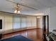 Open-concept living area featuring hardwood floors and natural light from vertical blinds at 1007 Forest Lake Dr, Lakeland, FL 33809