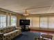 Spacious living room with laminate flooring, window treatments and entertainment center at 1007 Forest Lake Dr, Lakeland, FL 33809