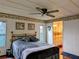 Comfortable bedroom featuring a ceiling fan and ensuite bathroom access at 1007 Forest Lake Dr, Lakeland, FL 33809