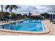 Community pool with a paved sun deck, umbrellas, and plenty of lounge seating at 1007 Forest Lake Dr, Lakeland, FL 33809