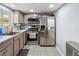 Well-lit kitchen features stainless steel appliances, granite countertops, and modern cabinetry at 1100 Martinique Dr # 202, Winter Haven, FL 33884
