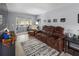 Comfortable living room featuring reclining leather sofa, sliding glass doors, and light wood floors at 1100 Martinique Dr # 202, Winter Haven, FL 33884