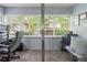 Cozy home office with dual workstations, comfortable chair, and natural light streaming through windows at 1100 Martinique Dr # 202, Winter Haven, FL 33884