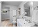 Bright bathroom with a modern sink, open shelving, a neutral color palette, and natural light at 1115 S Virginia Ave, Bartow, FL 33830