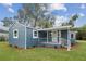 Charming home featuring a quaint porch with white railings and fresh landscaping at 1115 S Virginia Ave, Bartow, FL 33830