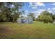 Exterior view of the shed on the property featuring coordinating paint and green surroundings at 1115 S Virginia Ave, Bartow, FL 33830