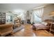 Bright living room with hardwood floors, a decorative fireplace, and large windows with elegant white drapes at 112 E Graham Park Dr, Haines City, FL 33844