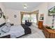 Bright bedroom featuring a ceiling fan, sitting area, and wood-look flooring at 1134 Waterfall Ln # 66, Lakeland, FL 33803