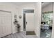 Bright foyer with gray wood-look floors, and a view into an eat-in kitchen with a breakfast nook at 1134 Waterfall Ln # 66, Lakeland, FL 33803