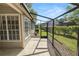 Screened-in porch overlooking a garden and lawn, great for outdoor entertaining at 1134 Waterfall Ln # 66, Lakeland, FL 33803