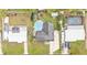 High aerial view of a single-story home featuring an in-ground pool, solar panels, and multiple cars at 1160 Ilene Ave, Bartow, FL 33830