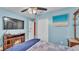 Light blue bedroom featuring a ceiling fan, TV, fireplace, and closet at 1160 Ilene Ave, Bartow, FL 33830