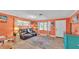 Bright living room showcasing coral-themed decor, comfortable seating, and ample natural light at 1160 Ilene Ave, Bartow, FL 33830