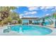 Backyard pool with patio, mural, and tropical landscaping at 1160 Ilene Ave, Bartow, FL 33830