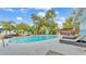 Backyard with a pool, lounge chairs, manicured landscaping, and fenced yard at 1160 Ilene Ave, Bartow, FL 33830