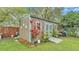 Outdoor shed with blue trim, offering extra storage space in a beautifully landscaped yard at 1160 Ilene Ave, Bartow, FL 33830