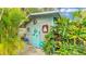 Charming shed with painted details and lush landscaping at 1160 Ilene Ave, Bartow, FL 33830