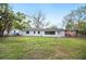 Rear view of home featuring a spacious yard at 1180 E Hill Ct, Bartow, FL 33830