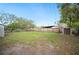 Large, fenced backyard with a storage shed and mature trees at 1180 E Hill Ct, Bartow, FL 33830